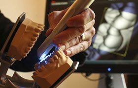 Dentist working on dental model